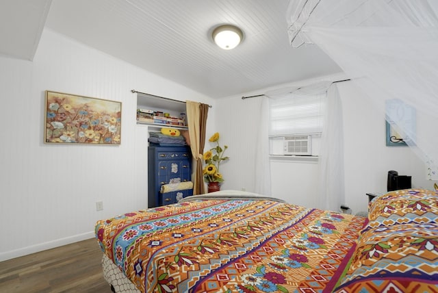 bedroom with cooling unit and dark wood-type flooring