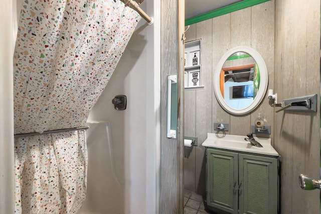 bathroom featuring vanity, curtained shower, and wood walls