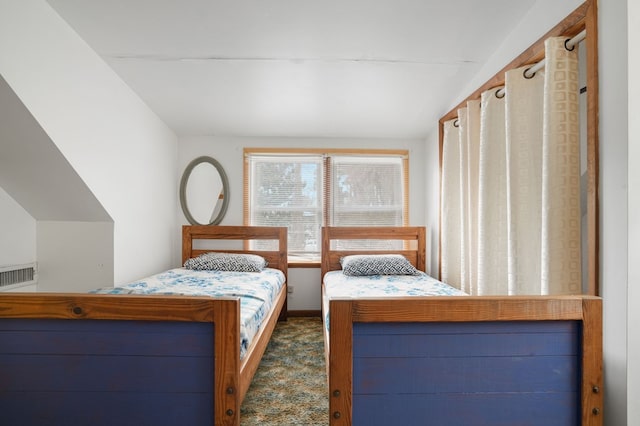 carpeted bedroom featuring lofted ceiling