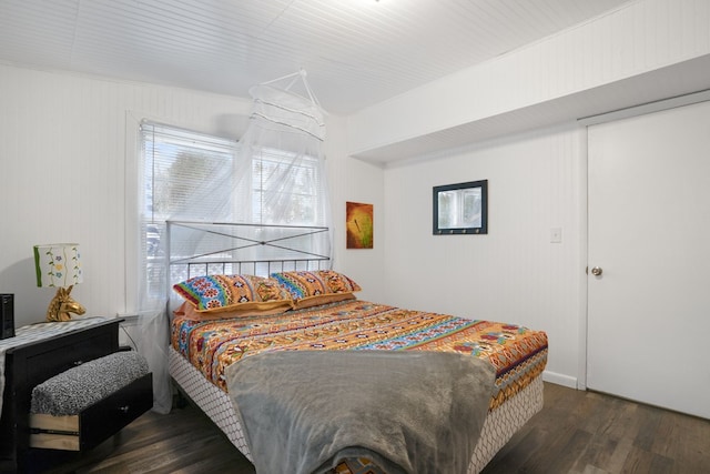 bedroom with dark wood-type flooring