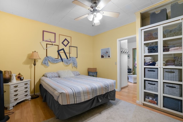 bedroom with hardwood / wood-style floors and ceiling fan