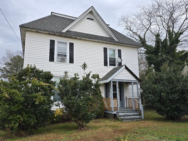 view of front of property with cooling unit and a front lawn