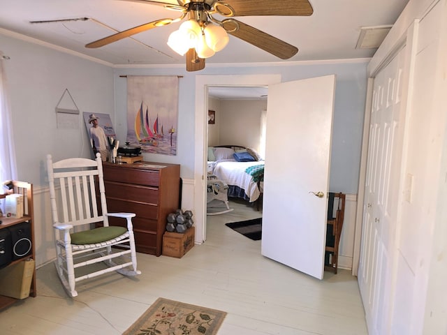 bedroom featuring ornamental molding, a closet, and ceiling fan