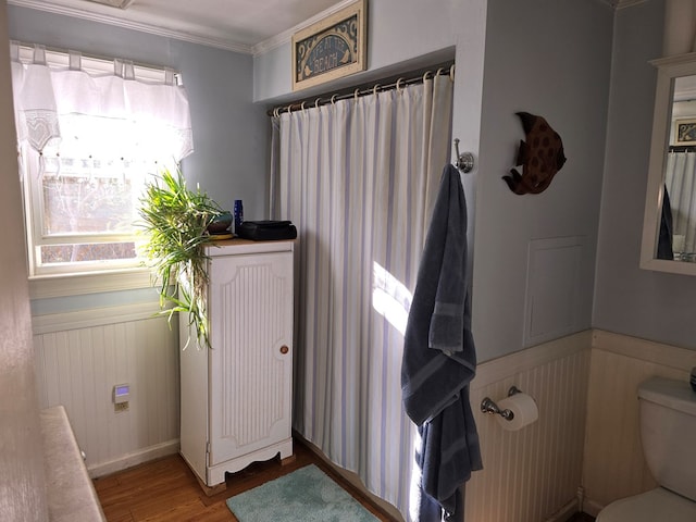 bathroom featuring crown molding, wood-type flooring, toilet, and radiator