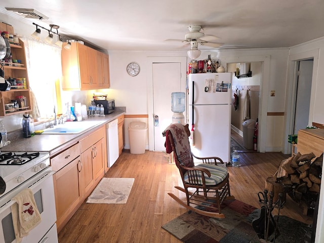 kitchen featuring sink, white appliances, light brown cabinets, ceiling fan, and light hardwood / wood-style floors