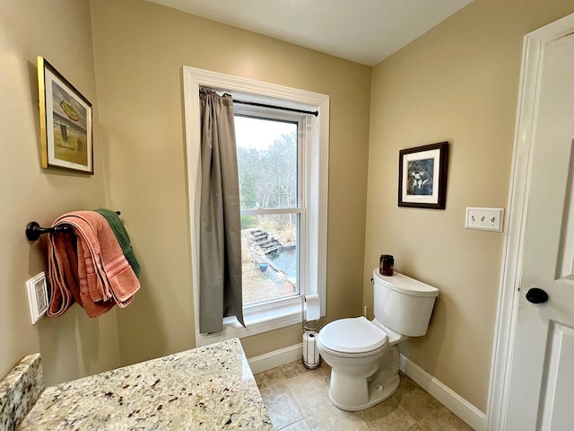 17481 Mitchell Ln, Parksley, VA 23421 - half bathroom with plenty of natural light, baseboards, and toilet