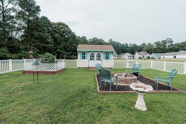 37275 Longboat Ct, Greenbackville, VA 23356 - fenced backyard with an outdoor fire pit and an outdoor structure