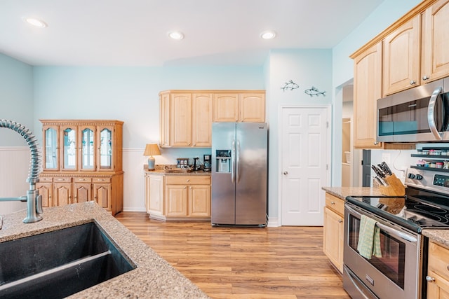 37275 Longboat Ct, Greenbackville, VA 23356 - kitchen featuring appliances with stainless steel finishes, light brown cabinetry, light wood-type flooring, light stone counters, and recessed lighting