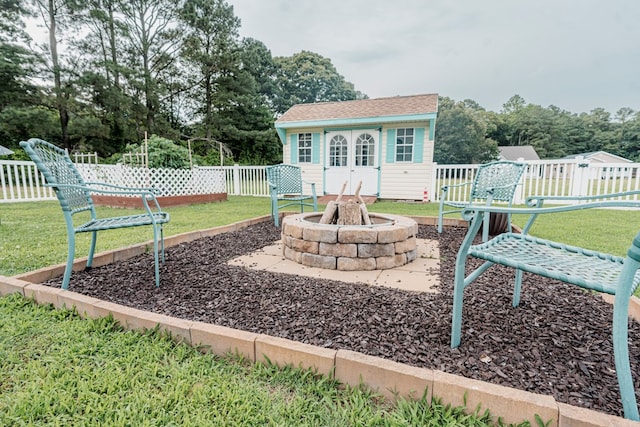 37275 Longboat Ct, Greenbackville, VA 23356 - view of yard featuring an outdoor structure, an outdoor fire pit, and view of scattered trees