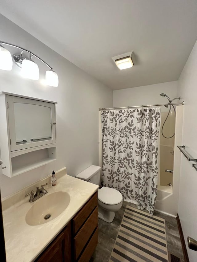 bathroom featuring toilet, shower / tub combo, and vanity