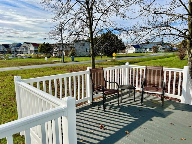 deck featuring a lawn and a residential view