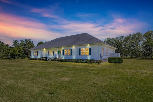 view of front of property with a lawn and covered porch