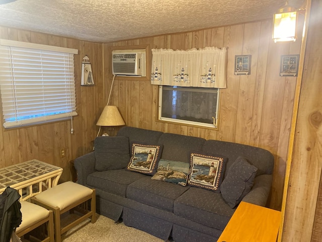 carpeted living room featuring a wall mounted air conditioner and wood walls