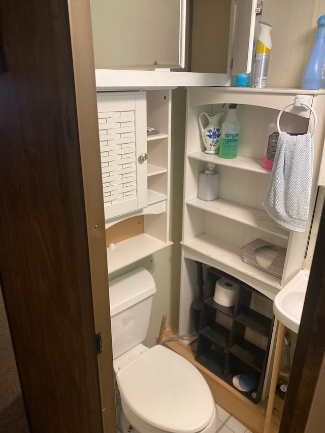 bathroom with tile patterned flooring and toilet