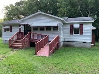 rear view of property with a lawn