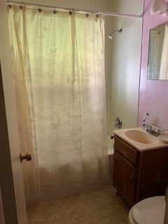 full bathroom featuring shower / bath combination with curtain, toilet, and vanity