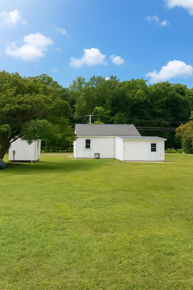 3469 Willis Wharf Rd, Exmore, VA 23350 - view of green lawn with an outdoor structure and a garage