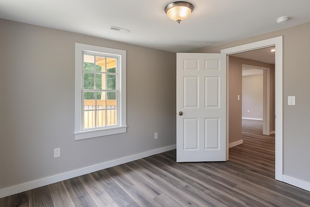 3469 Willis Wharf Rd, Exmore, VA 23350 - unfurnished bedroom with baseboards and dark wood finished floors
