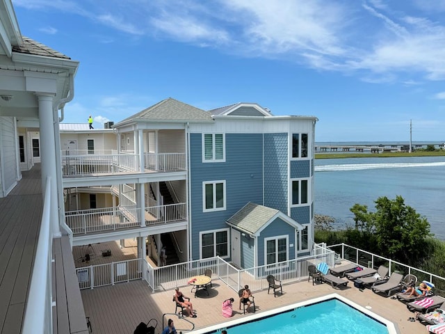 exterior space featuring a water view and a fenced in pool