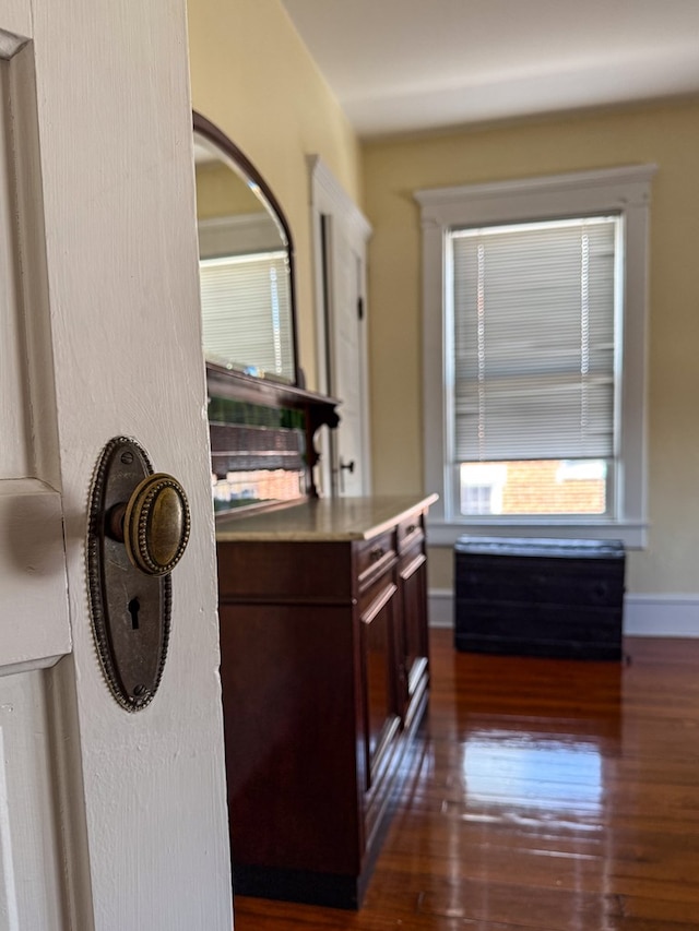 interior space with dark wood finished floors and baseboards