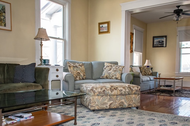 living room featuring a ceiling fan and wood finished floors