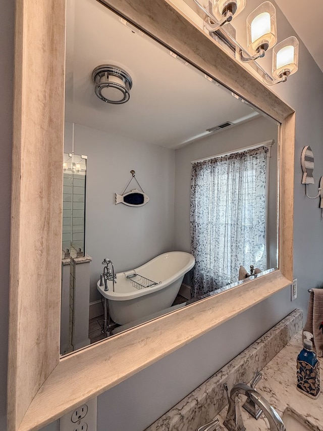 bathroom featuring a soaking tub and visible vents