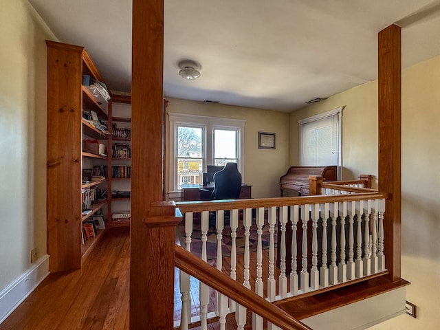 interior space featuring baseboards and wood finished floors