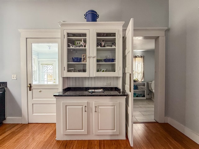 bar with light wood-style flooring and baseboards