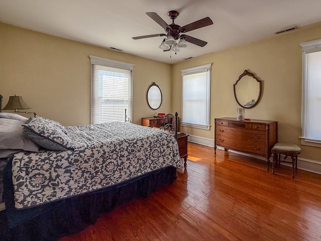 bedroom featuring baseboards, visible vents, and hardwood / wood-style floors