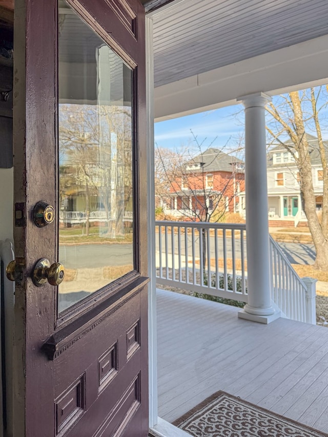 doorway featuring plenty of natural light and ornate columns