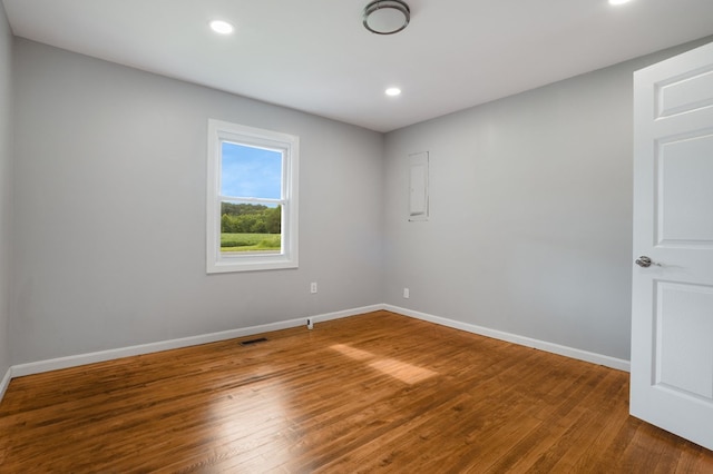 unfurnished room with hardwood / wood-style floors