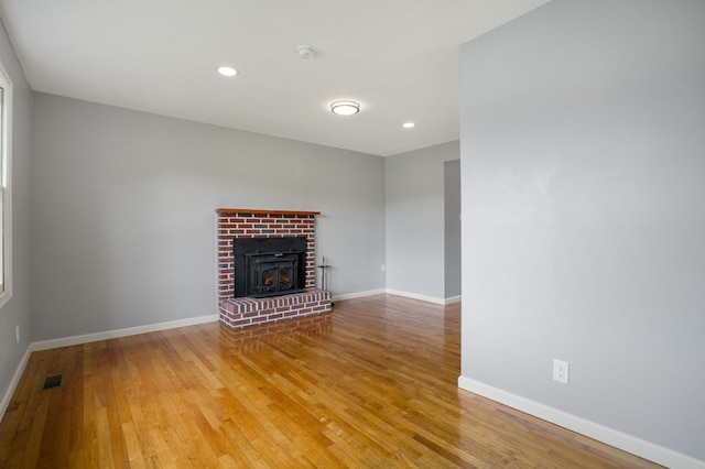 unfurnished living room with a fireplace and hardwood / wood-style floors