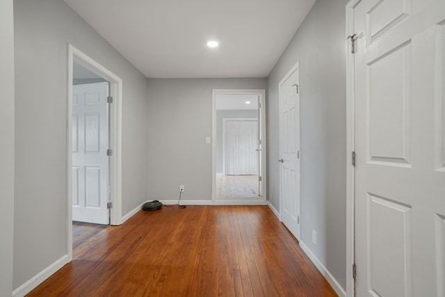 corridor with dark wood-type flooring