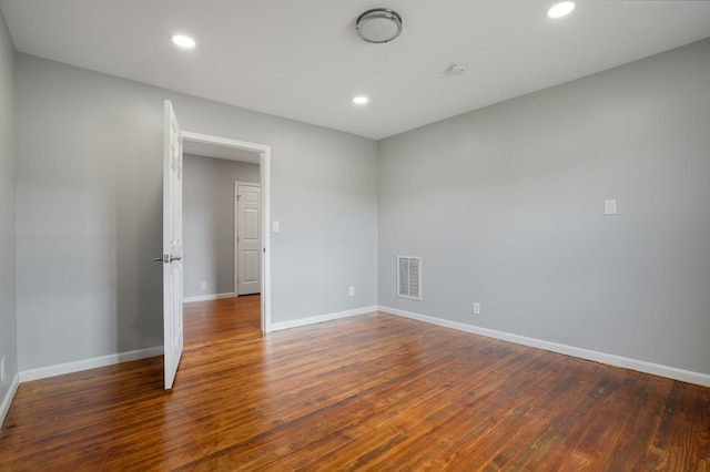 unfurnished room featuring dark hardwood / wood-style flooring