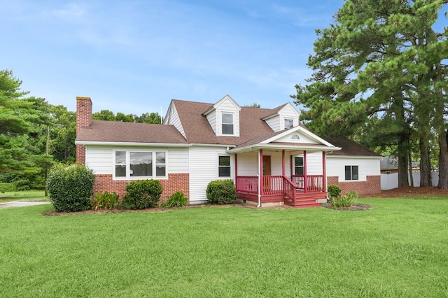 cape cod-style house featuring covered porch and a front lawn