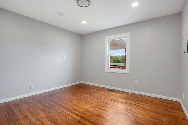 unfurnished room with hardwood / wood-style floors