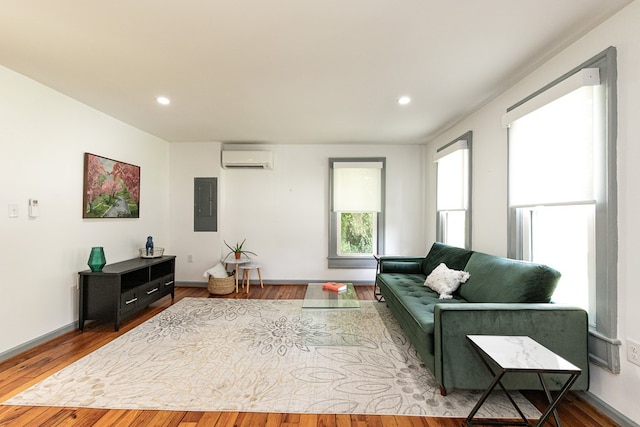 living room featuring wood-type flooring and a wall mounted air conditioner