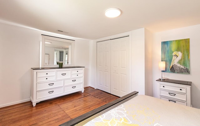 bedroom featuring wood-type flooring and a closet