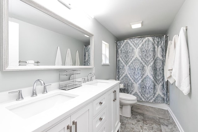 bathroom with vanity, toilet, and curtained shower