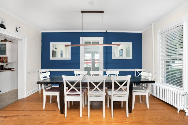 dining room featuring ornamental molding, radiator heating unit, wood finished floors, and breakfast area