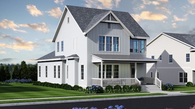 view of front of property with covered porch and a front yard