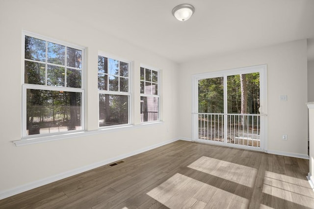 unfurnished sunroom with visible vents