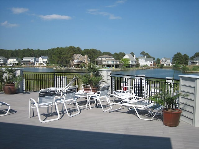 wooden deck featuring a water view and a residential view