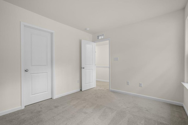 unfurnished bedroom with carpet floors, visible vents, and baseboards