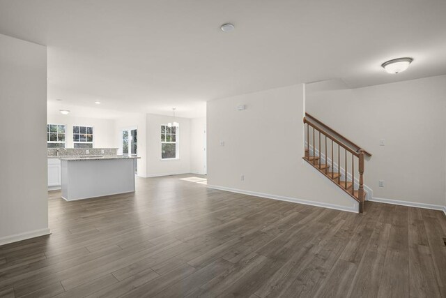 kitchen with white cabinetry, a center island, stainless steel appliances, light hardwood / wood-style flooring, and a breakfast bar