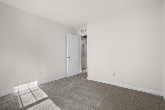 carpeted spare room with baseboards and visible vents