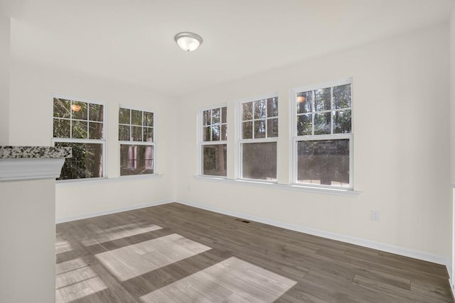 unfurnished sunroom with a wealth of natural light and visible vents