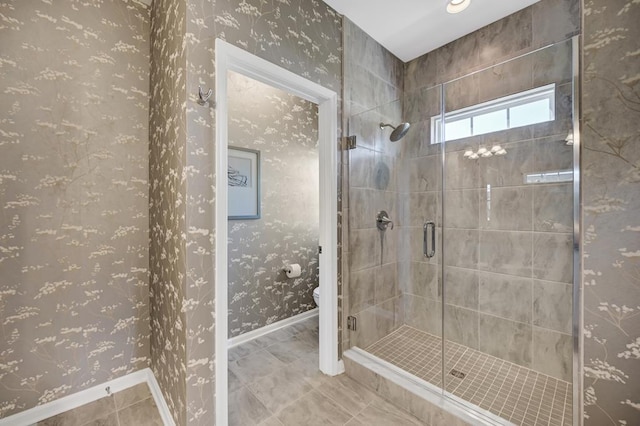 bathroom featuring walk in shower, tile patterned flooring, and toilet