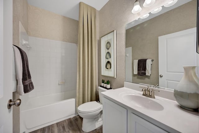 full bathroom featuring hardwood / wood-style floors, vanity, toilet, and shower / tub combo with curtain