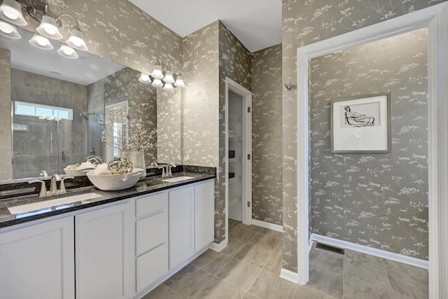 bathroom featuring tile patterned flooring, vanity, and a shower with door